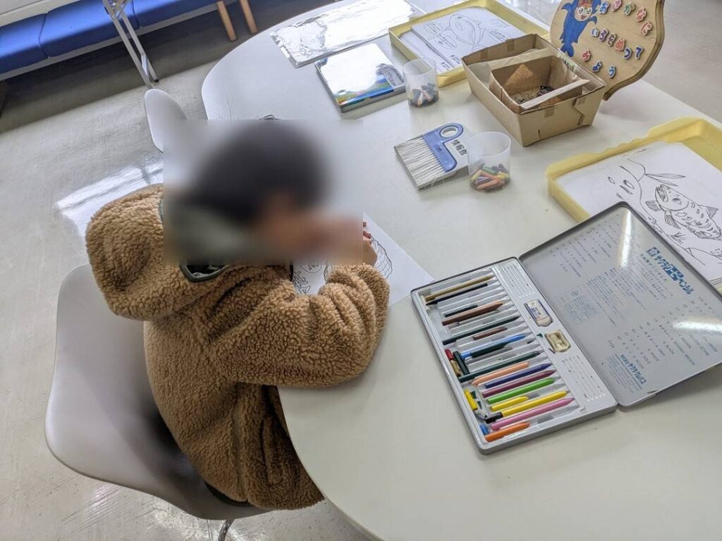 子どもが水産動物の塗り絵をしている様子